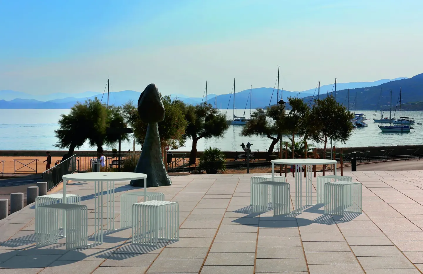 Zeroquindici.015 Octopus tables and cube seats on a waterfront terrace