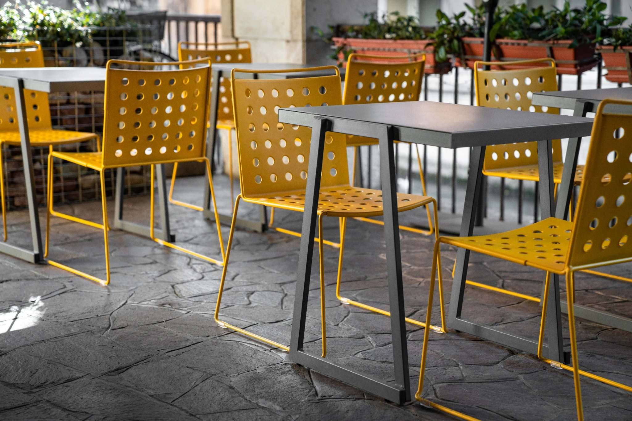 White Busy chairs around an outdoor table beside a swimming pool