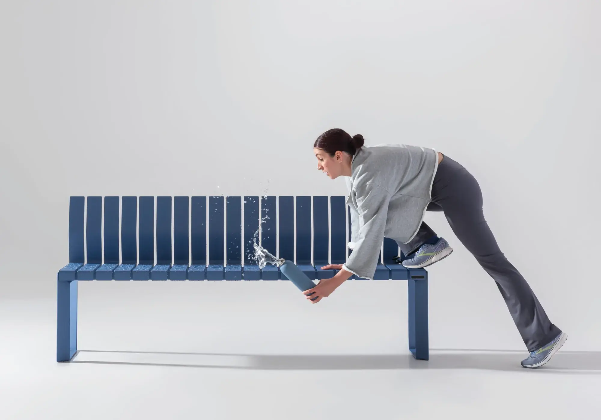 A blue Liberty.080 bench with a runner stretching against it
