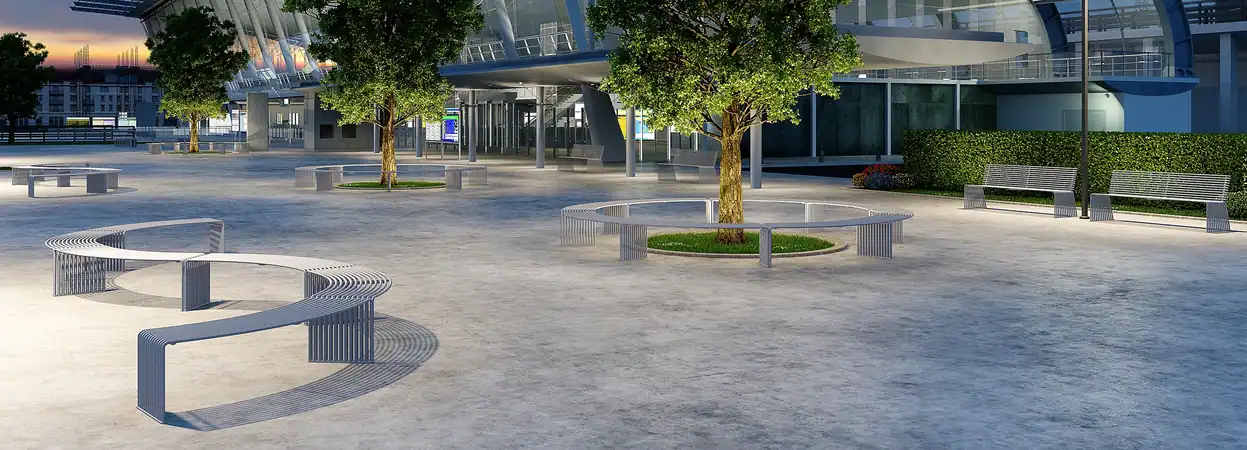 Zeroquindici.015 curved benches and a circular tree-ring bench in a transit plaza at dusk, straight benches and tables beyond