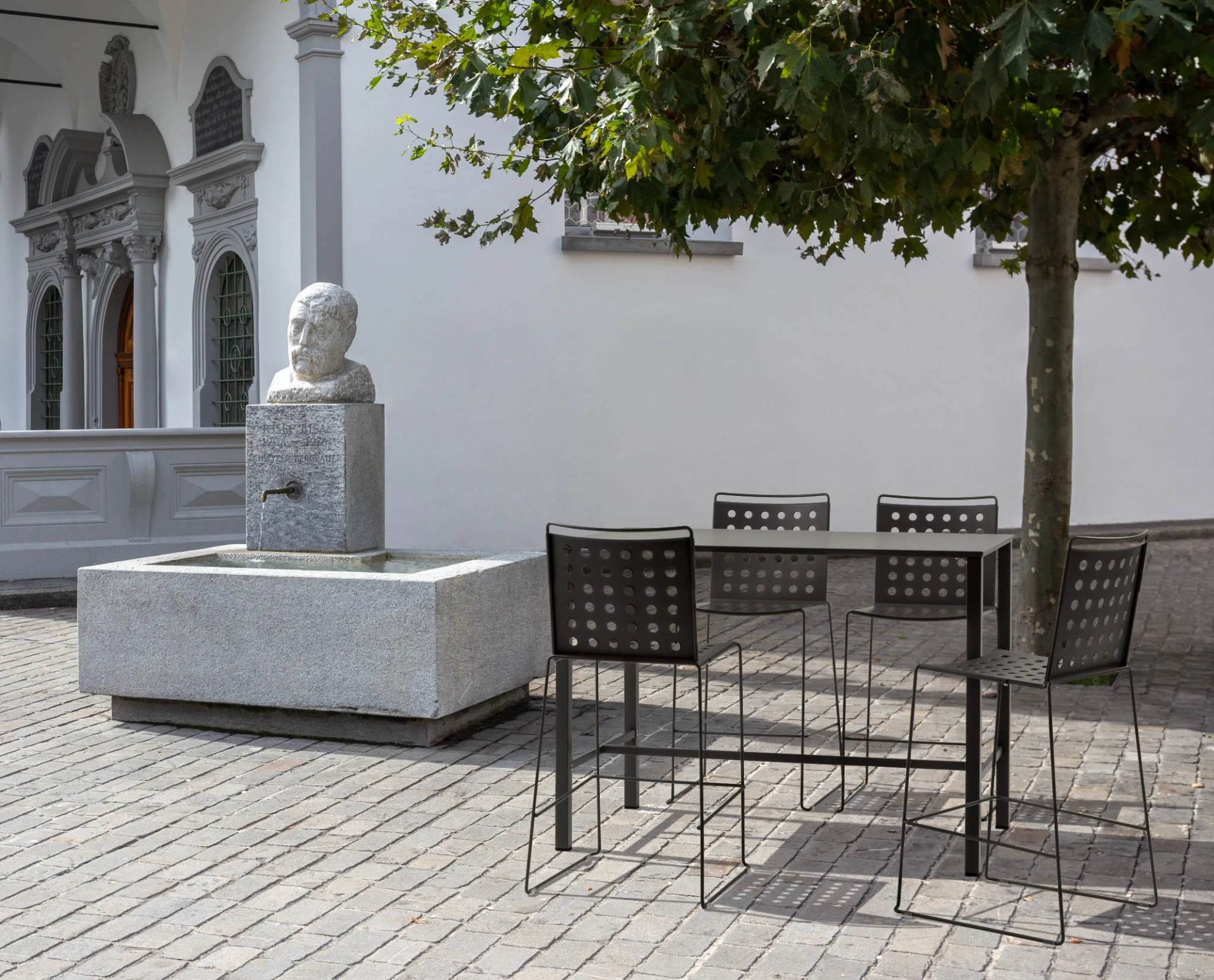 Moontable high tables in an outdoor courtyard